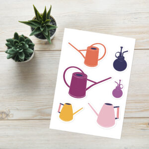 Indoor Gardening: Watering Cans Sticker Sheet is displayed on a wood textured background