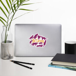 Curiosity Cats: Be Curious sticker (Yellow & Pink) on a laptop