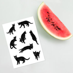Black Cats Chilling: Block Print Style Sticker Sheet is displayed next to a watermelon for scale.