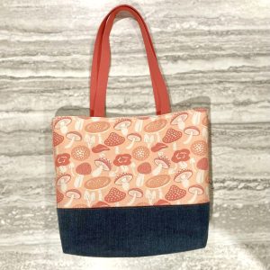Large tote bag with coral and peach mushroom print feature fabric and denim base fabric.
